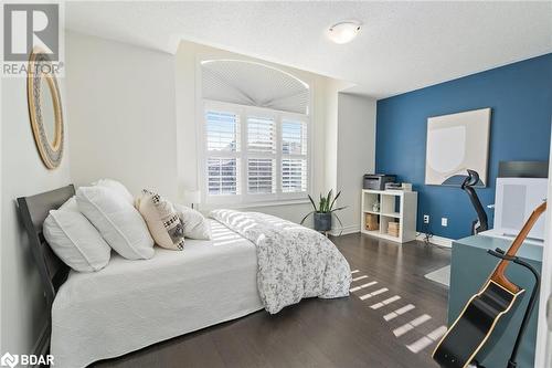 Bedroom with dark hardwood / wood-style flooring and a textured ceiling - 19 Mugford Crescent, Brampton, ON - Indoor Photo Showing Bedroom