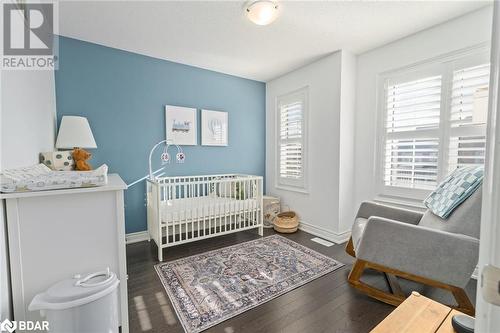 Bedroom with a crib, a textured ceiling, and dark hardwood / wood-style flooring - 19 Mugford Crescent, Brampton, ON - Indoor Photo Showing Bedroom