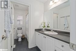 Bathroom featuring toilet, vanity, and tile patterned floors - 