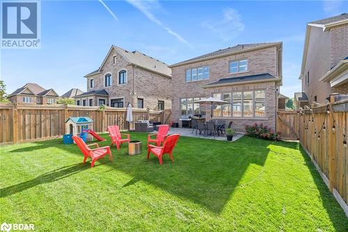 Rear view of house with a patio area and a yard - 19 Mugford Crescent, Brampton, ON - Outdoor