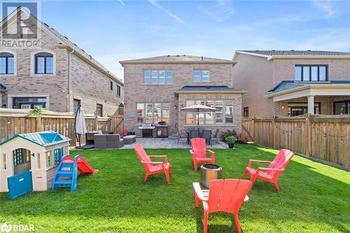 Back of property with a lawn, a patio area, and an outdoor hangout area - 19 Mugford Crescent, Brampton, ON - Outdoor