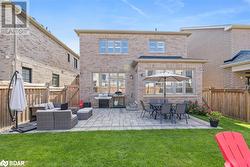 Rear view of house featuring an outdoor living space, a patio area, and a lawn - 