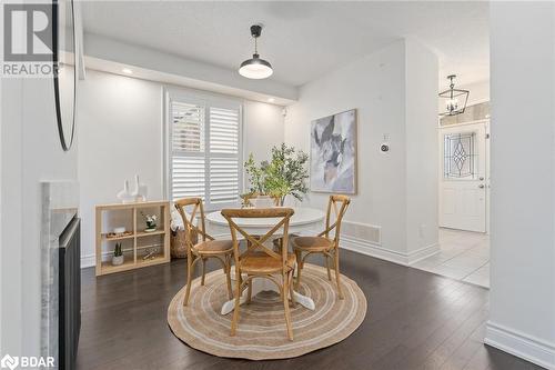 Dining area featuring wood-type flooring and a chandelier - 19 Mugford Crescent, Brampton, ON - Indoor Photo Showing Dining Room