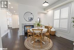 Dining room featuring a multi sided fireplace and dark hardwood / wood-style flooring - 