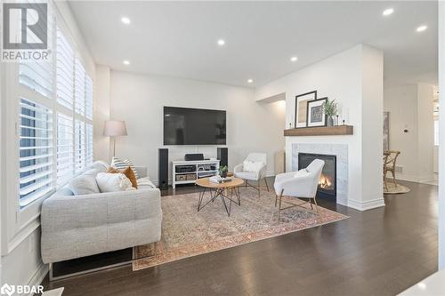 Living room with dark wood-type flooring - 19 Mugford Crescent, Brampton, ON - Indoor Photo Showing Living Room With Fireplace