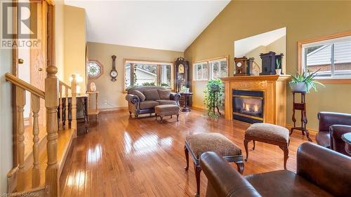 Living room featuring hardwood / wood-style floors, high vaulted ceiling, and a healthy amount of sunlight - 490 7Th Street W, Owen Sound, ON - Indoor Photo Showing Living Room With Fireplace