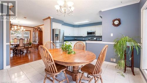 Tiled dining room with crown molding, a textured ceiling, and a notable chandelier - 490 7Th Street W, Owen Sound, ON - Indoor Photo Showing Dining Room