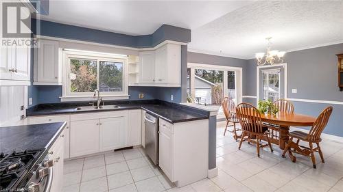 Kitchen with appliances with stainless steel finishes, a textured ceiling, white cabinetry, and sink - 490 7Th Street W, Owen Sound, ON - Indoor