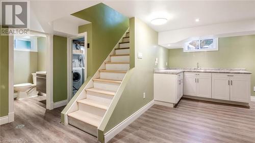 Stairs featuring washer / clothes dryer, hardwood / wood-style floors, and sink - 490 7Th Street W, Owen Sound, ON - Indoor Photo Showing Other Room