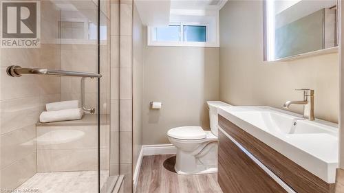 Bathroom with vanity, toilet, wood-type flooring, and walk in shower - 490 7Th Street W, Owen Sound, ON - Indoor Photo Showing Bathroom