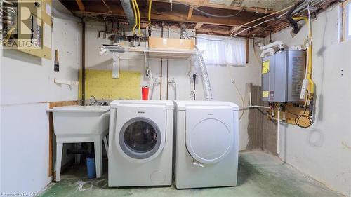 Laundry area with separate washer and dryer and water heater - 490 7Th Street W, Owen Sound, ON - Indoor Photo Showing Laundry Room