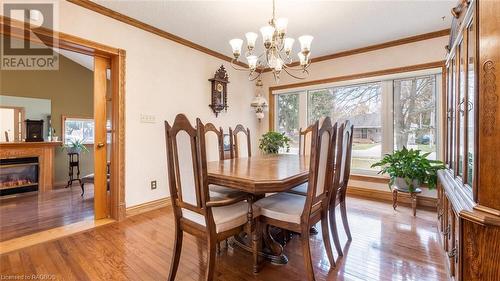 Dining area featuring lofted ceiling, light hardwood / wood-style floors, crown molding, and a notable chandelier - 490 7Th Street W, Owen Sound, ON - Indoor Photo Showing Dining Room With Fireplace