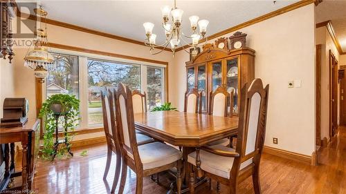 Dining space featuring crown molding, light hardwood / wood-style flooring, and a chandelier - 490 7Th Street W, Owen Sound, ON - Indoor Photo Showing Dining Room