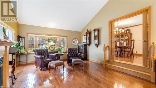 Living area with hardwood / wood-style floors, high vaulted ceiling, and an inviting chandelier - 490 7Th Street W, Owen Sound, ON - Indoor With Fireplace