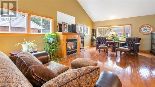 Living room with a wealth of natural light, high vaulted ceiling, and light hardwood / wood-style floors - 490 7Th Street W, Owen Sound, ON - Indoor Photo Showing Living Room With Fireplace