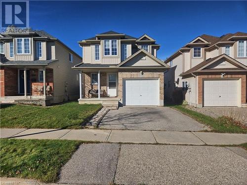 View of front of house featuring a garage, a front yard, and a porch - 973 Atlantic Boulevard, Waterloo, ON - Outdoor With Facade