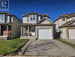 View of front of property with a garage and covered porch - 