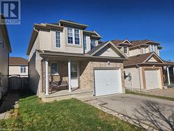 View of front facade featuring a garage and a porch - 