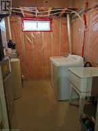 Laundry room with sink and separate washer and dryer - 