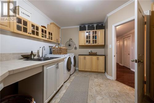 laundry room with storage and cabinetry - 68 Beaver Creek Trail, Pembroke, ON - Indoor Photo Showing Laundry Room