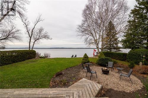 fire pit and deck area - 68 Beaver Creek Trail, Pembroke, ON - Outdoor With Body Of Water