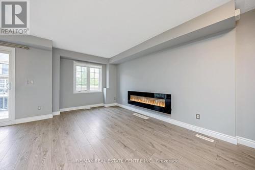 100 - 620 Ferguson Drive, Milton, ON - Indoor Photo Showing Living Room With Fireplace