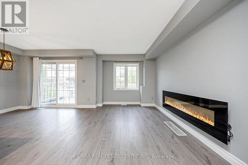 100 - 620 Ferguson Drive, Milton, ON - Indoor Photo Showing Living Room With Fireplace