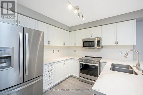 100 - 620 Ferguson Drive, Milton, ON - Indoor Photo Showing Kitchen With Double Sink