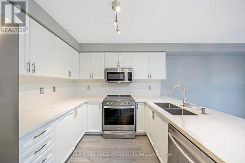 100 - 620 Ferguson Drive, Milton, ON - Indoor Photo Showing Kitchen With Double Sink