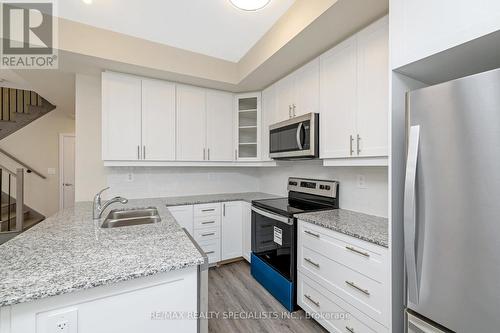 108 - 1569 Rose Way, Milton, ON - Indoor Photo Showing Kitchen With Stainless Steel Kitchen With Double Sink With Upgraded Kitchen