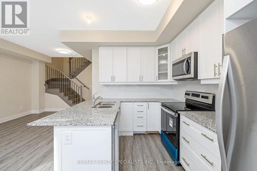 108 - 1569 Rose Way, Milton, ON - Indoor Photo Showing Kitchen With Stainless Steel Kitchen With Double Sink With Upgraded Kitchen