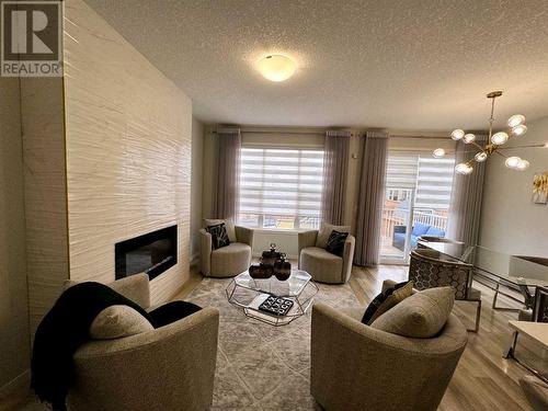 20 Cranbrook Green Se, Calgary, AB - Indoor Photo Showing Living Room With Fireplace