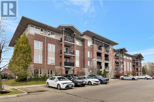 View of building exterior - 41 Goodwin Drive Unit# 306, Guelph, ON - Outdoor With Balcony With Facade