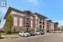 View of building exterior - 41 Goodwin Drive Unit# 306, Guelph, ON  - Outdoor With Balcony With Facade 