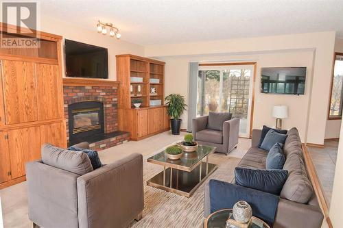 Main Floor Family Room - Virtually Staged - 175 Douglasbank Drive Se, Calgary, AB - Indoor Photo Showing Living Room With Fireplace