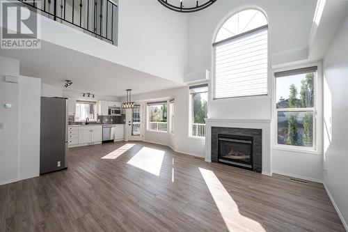 298 Arbour Crest Drive Nw, Calgary, AB - Indoor Photo Showing Living Room With Fireplace