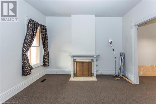 Unit 56 Unfurnished living room featuring dark carpet - 60 Wellington St N/S Street N, Woodstock, ON - Indoor Photo Showing Other Room