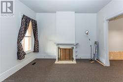 Unit 56 Unfurnished living room featuring dark carpet - 