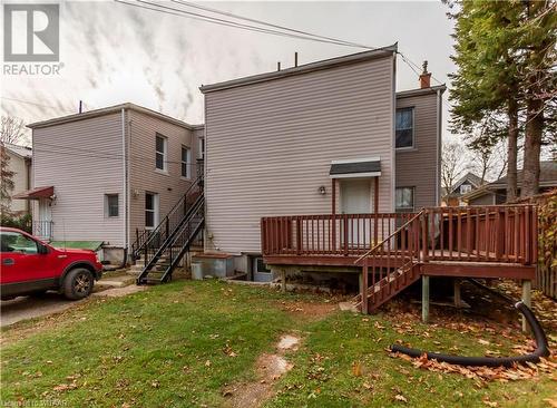 Back of property with a yard and a wooden deck - 60 Wellington St N/S Street N, Woodstock, ON - Outdoor With Exterior