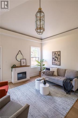 Living room featuring hardwood / wood-style floors and vaulted ceiling - 109 East Avenue S, Hamilton, ON - Indoor Photo Showing Living Room