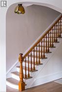 Stairway featuring hardwood / wood-style flooring - 