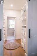 Walk in closet featuring light hardwood / wood-style flooring - 