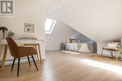 Bedroom with lofted ceiling with skylight and light hardwood / wood-style floors - 109 East Avenue S, Hamilton, ON - Indoor Photo Showing Other Room