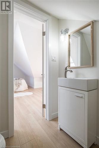 Bathroom featuring vanity and hardwood / wood-style flooring - 109 East Avenue S, Hamilton, ON - Indoor Photo Showing Bathroom