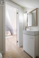 Bathroom featuring vanity and hardwood / wood-style flooring - 