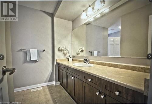 Bathroom featuring tile patterned flooring and vanity - 906 Farmstead Drive, Milton, ON - Indoor Photo Showing Bathroom