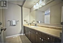 Bathroom featuring tile patterned flooring and vanity - 