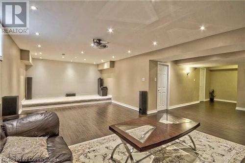 Home theater with dark wood-type flooring - 906 Farmstead Drive, Milton, ON - Indoor