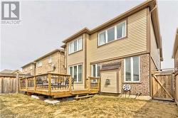 Rear view of house with a yard and a deck - 