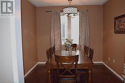 Dining room with dark wood-type flooring - 